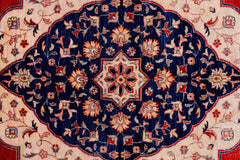 A handwoven Afghan Balkh rug featuring a central floral medallion on a deep blue field.
