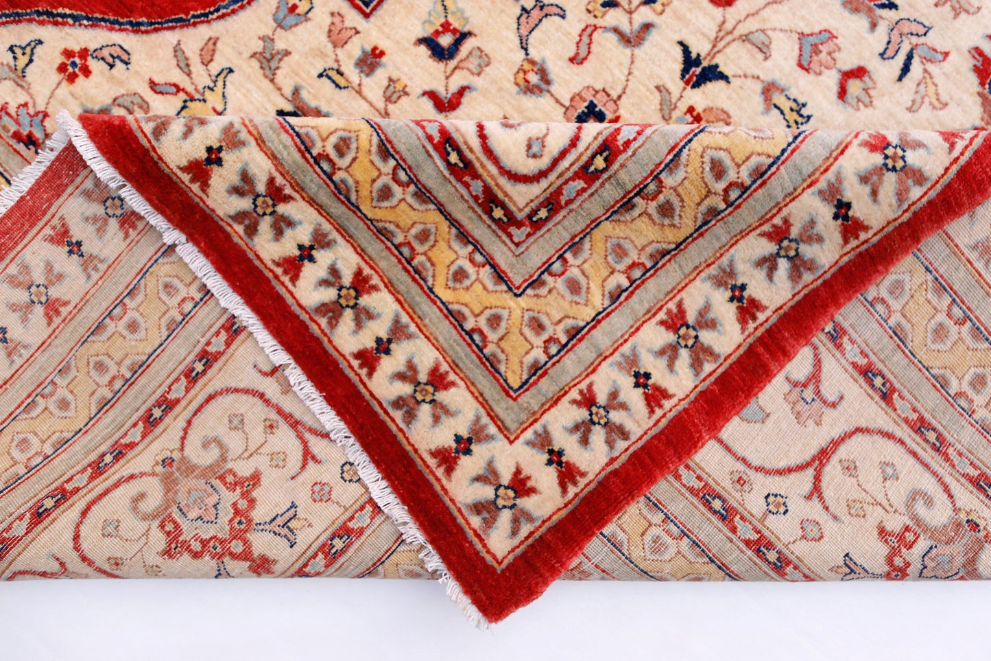 A handwoven Afghan Balkh rug featuring a traditional floral pattern in red and cream tones.