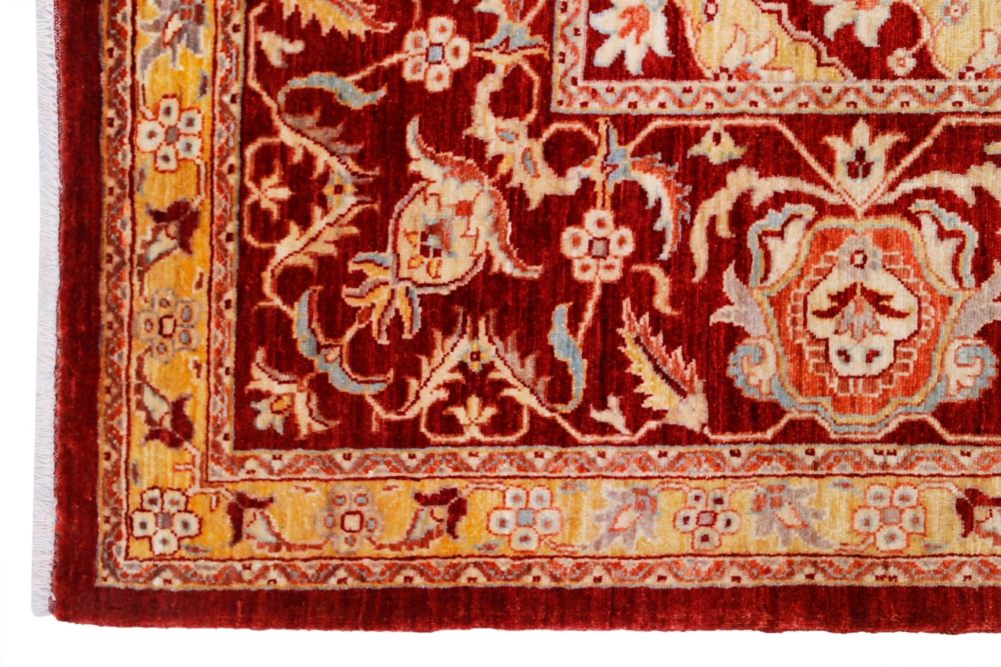 A handwoven Afghan Balkh rug featuring a traditional floral pattern in deep red and gold tones.