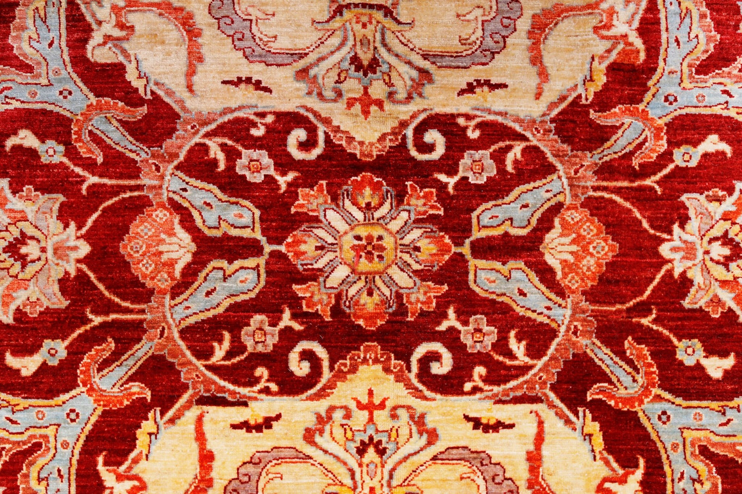 A handwoven Afghan Balkh rug featuring a traditional floral pattern in red, cream, and blue tones.