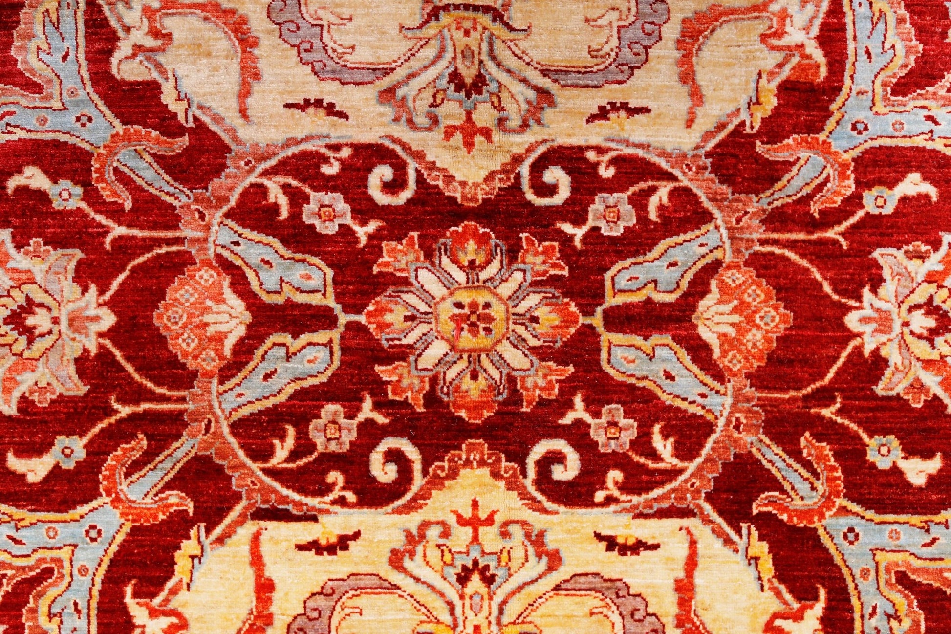 A handwoven Afghan Balkh rug featuring a traditional floral pattern in red, cream, and blue tones.