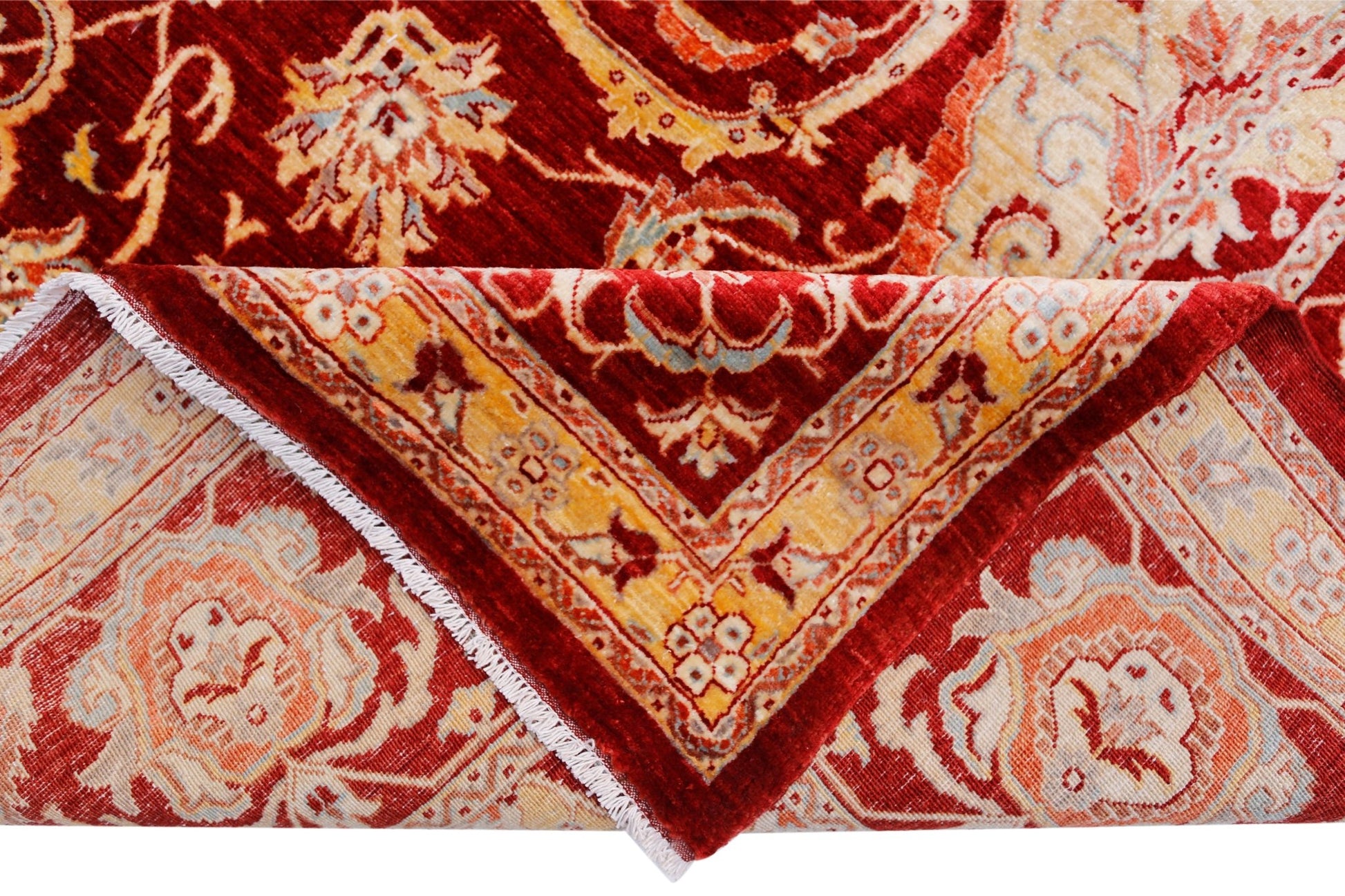 A handwoven Afghan Balkh rug featuring a traditional floral pattern in red, orange, and cream tones.