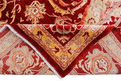 A handwoven Afghan Balkh rug featuring a traditional floral pattern in red, orange, and cream tones.