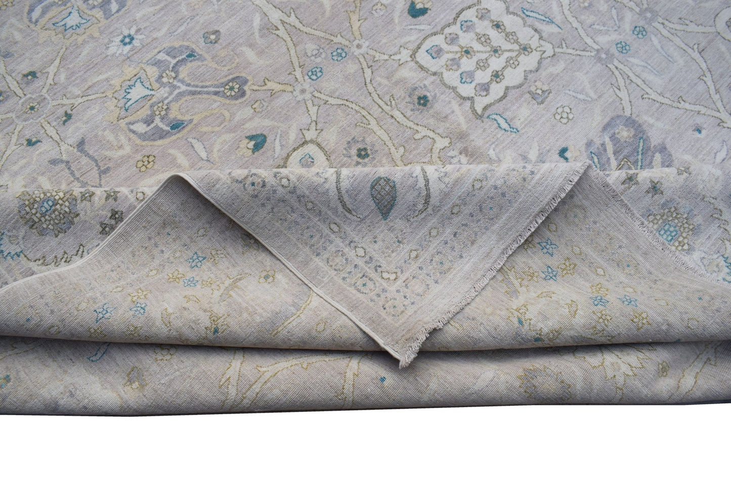 A handwoven Afghan Balkh rug featuring a traditional floral pattern in soft neutral tones.