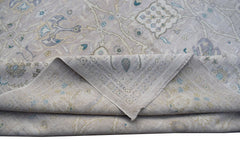 A handwoven Afghan Balkh rug featuring a traditional floral pattern in soft neutral tones.