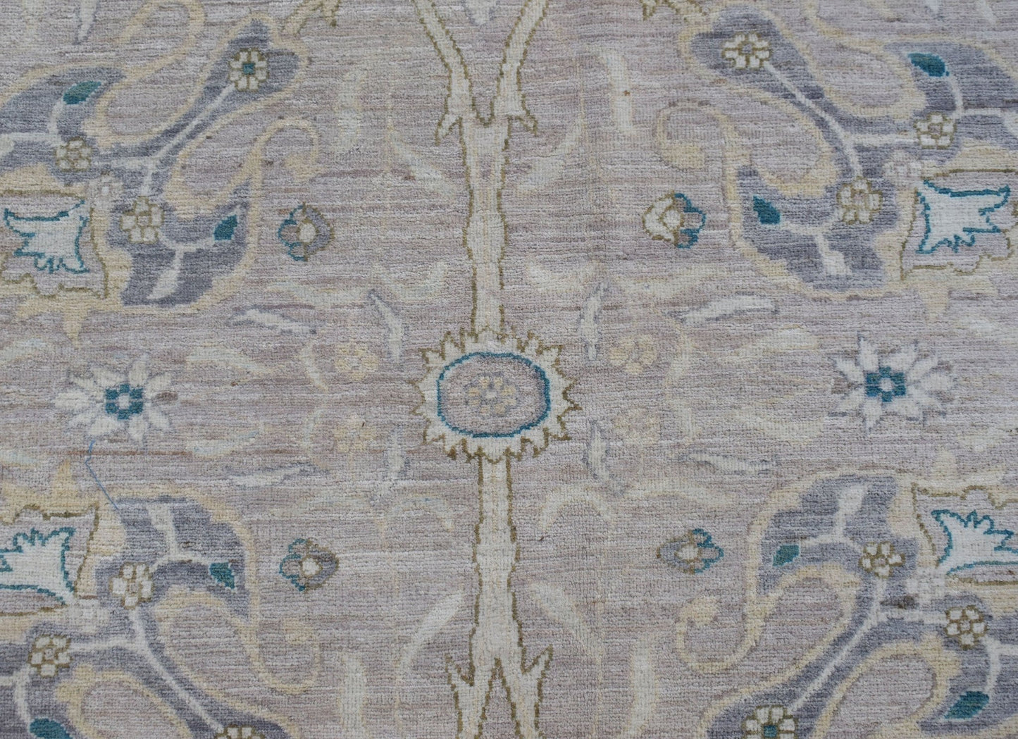 A handwoven Afghan Balkh rug featuring a traditional floral pattern in soft neutral tones.