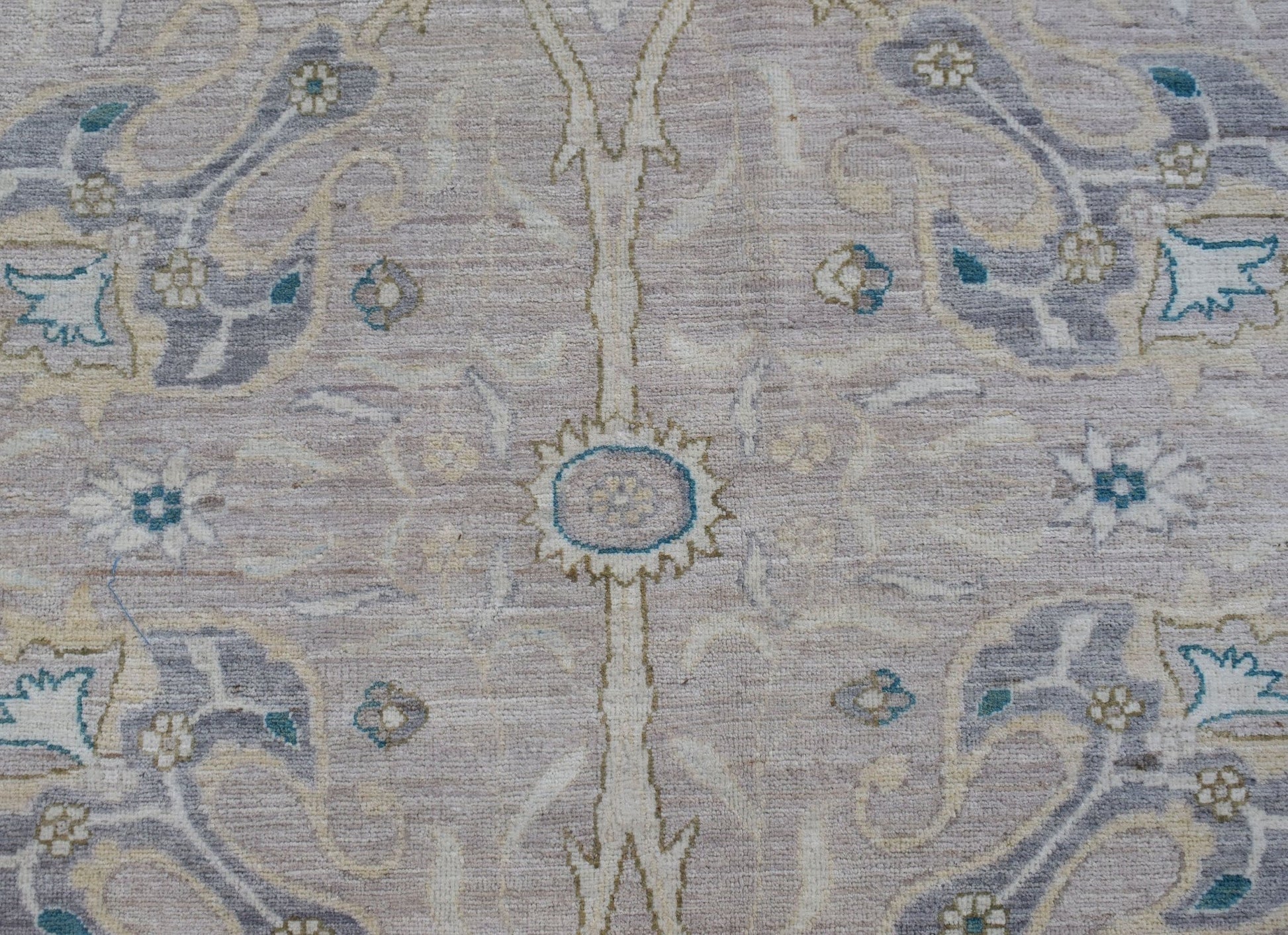 A handwoven Afghan Balkh rug featuring a traditional floral pattern in soft neutral tones.