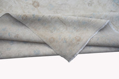 A handwoven Afghan Balkh rug featuring a neutral palette with subtle blue and beige floral motifs.