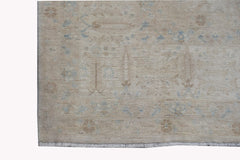 A handwoven Afghan Balkh rug featuring a traditional Chobi pattern in soft beige and blue tones.