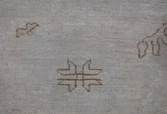 A handwoven Afghan Balkh rug featuring a minimalist geometric motif on a light wool background.