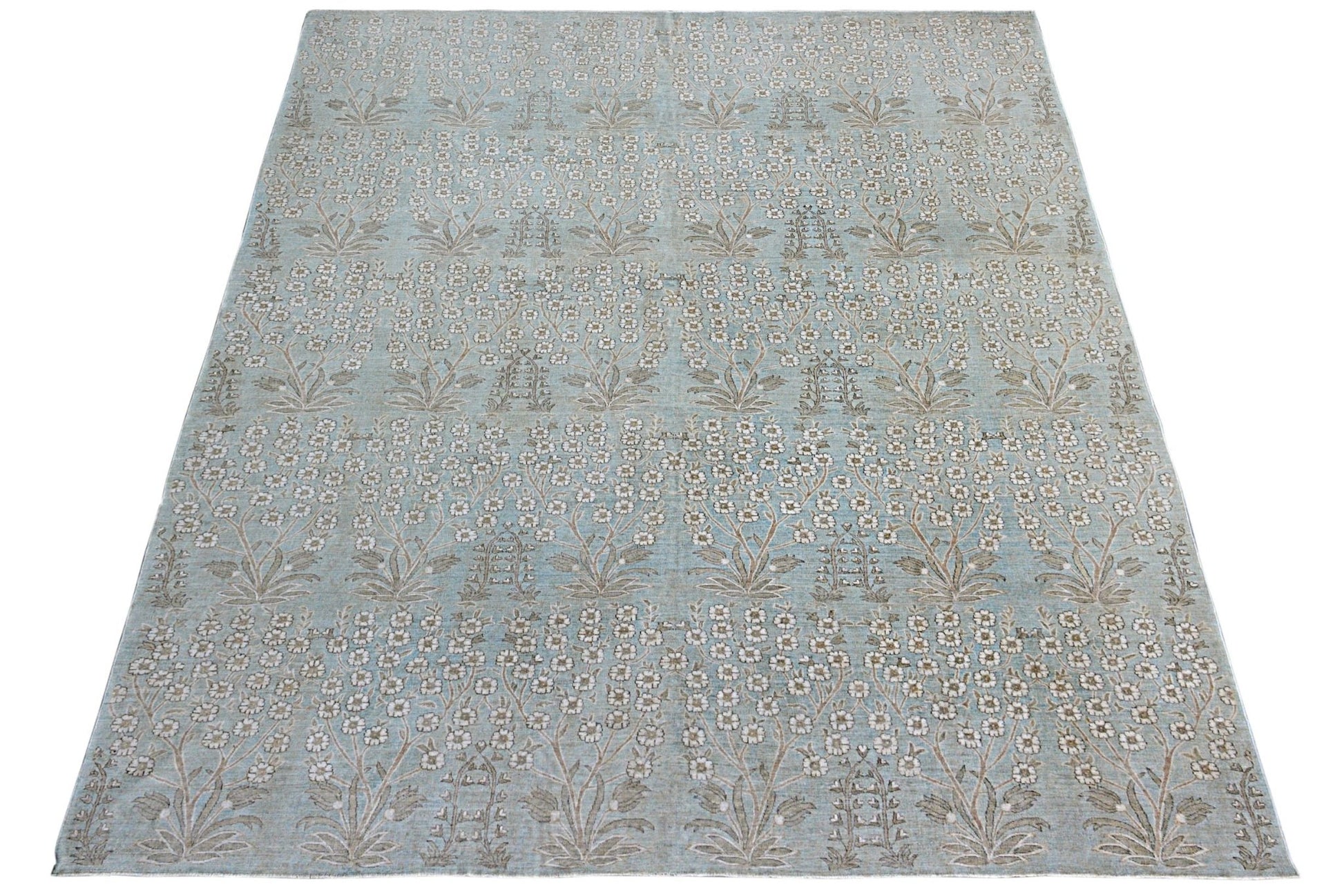 An Afghan Balkh rug featuring a repeating floral pattern in soft blue and neutral tones.
