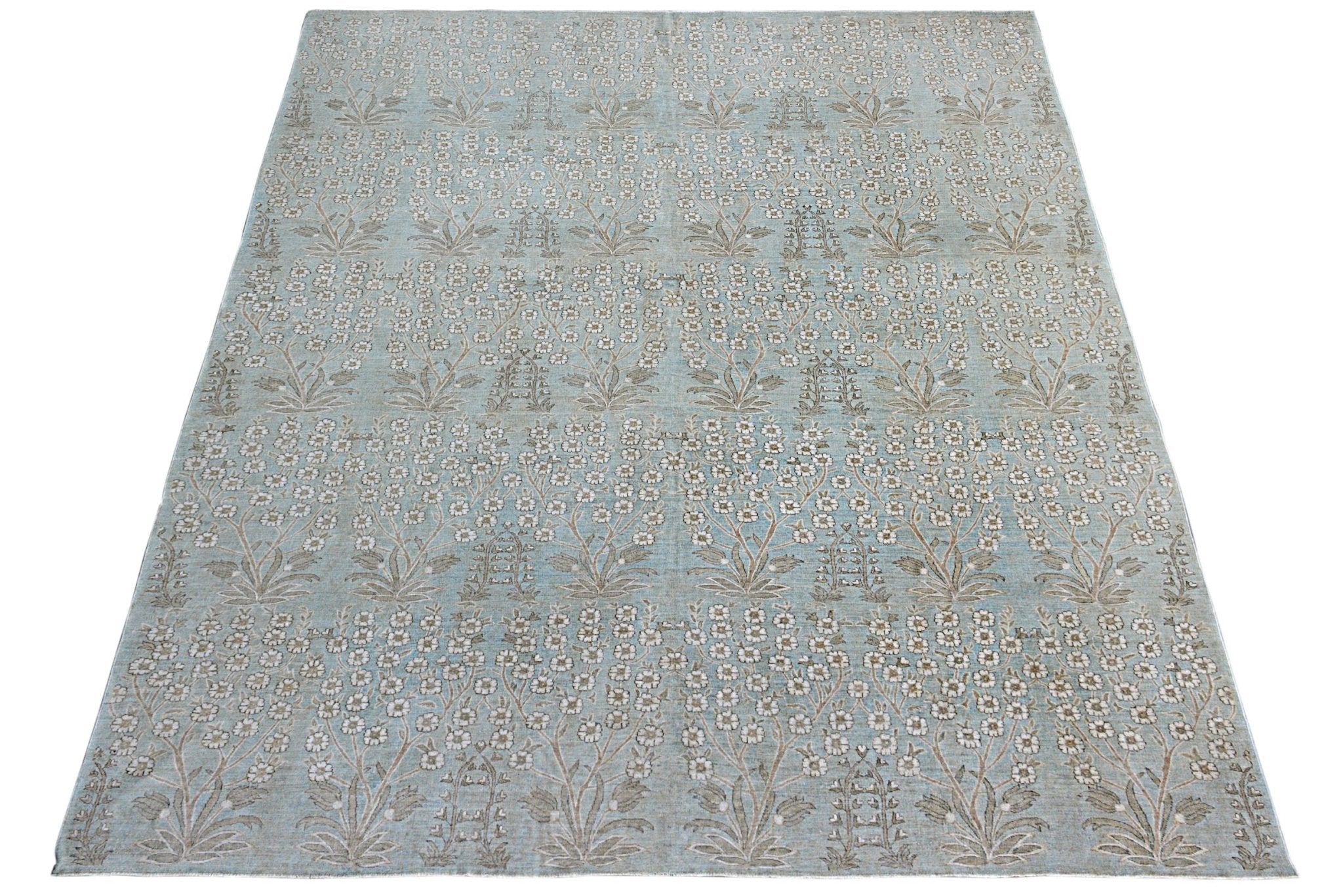 An Afghan Balkh rug featuring a repeating floral pattern in soft blue and neutral tones.