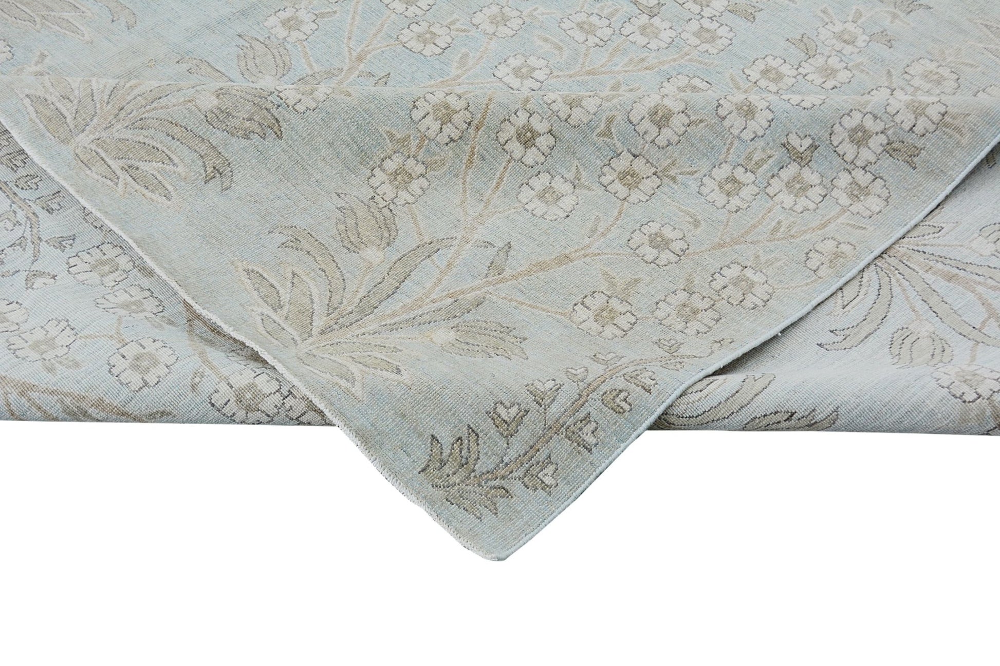 A handmade Afghan Balkh rug featuring a light blue field with a beige floral pattern.