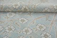 A handmade Afghan Balkh rug featuring a light blue field with a beige floral vine pattern.