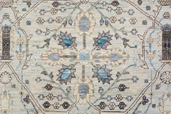 An Afghan Balkh rug featuring a traditional floral medallion pattern in blue and beige tones.