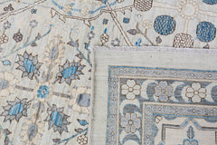 A handmade Afghan Balkh rug featuring a traditional floral pattern in blue, grey, and cream tones.
