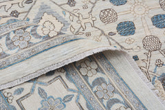 A handmade Afghan Balkh rug featuring a traditional floral pattern in blue, grey, and cream tones.