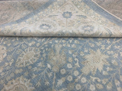 A handmade Afghan Balkh rug featuring a traditional floral pattern in shades of blue and cream.
