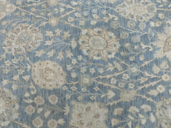 An Afghan Balkh rug featuring a traditional floral pattern in shades of blue and beige.