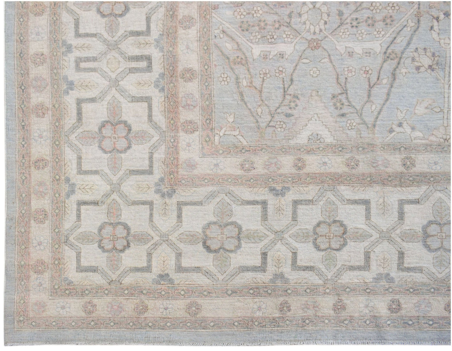 Handwoven Afghan Balkh rug featuring a traditional floral pattern in soft blue and beige tones.