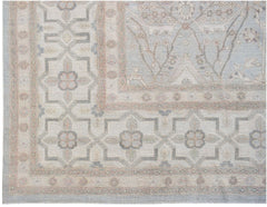 Handwoven Afghan Balkh rug featuring a traditional floral pattern in soft blue and beige tones.
