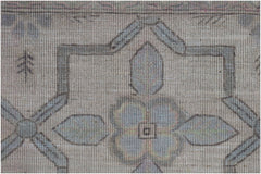 A close-up of a handwoven Afghan Balkh rug featuring a traditional geometric floral pattern.