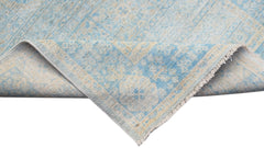 A handwoven Afghan Chobi runner featuring a light blue and cream Mamluk medallion pattern.