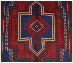 Handmade Afghan Baluch rug featuring a geometric central medallion in red, blue, and ivory wool.