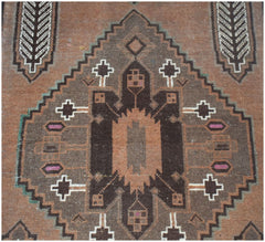 Handmade Afghan Baluch rug featuring a geometric brown and orange diamond pattern.