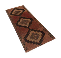A handmade Afghan Baluch runner rug featuring three dark brown diamond medallions on a red field.
