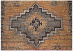 Handmade Afghan Baluch rug featuring a geometric diamond medallion in brown on an orange field.