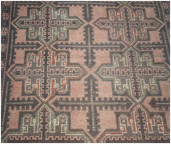 Handmade Afghan Baluch rug featuring a geometric cross pattern in muted pink, brown, and green.