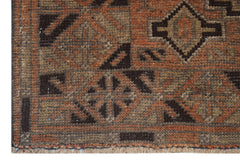 Handmade Afghan Baluch rug featuring a geometric pattern in shades of brown and rust orange.
