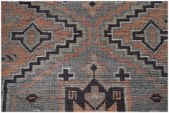 Handmade Afghan Baluch rug featuring a geometric pattern in shades of grey and terracotta.