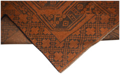 A handmade Afghan Baluch rug featuring a geometric pattern in shades of brown and rust orange.