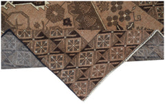 A handmade Afghan Baluch rug featuring geometric patterns in shades of brown and tan.
