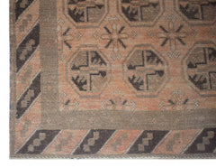 Handmade Afghan Baluch rug featuring geometric octagonal motifs in brown and terracotta tones.