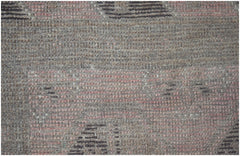 A close-up of a handmade Afghan Baluch rug featuring a textured wool weave in earthy tones.