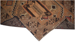 Handmade Afghan Baluch rug featuring geometric patterns in shades of brown and orange.