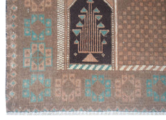 Handmade Afghan Baluch rug featuring a brown field with geometric motifs and a central tree design.