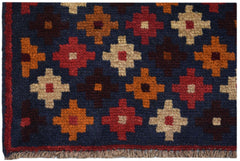 Handmade Afghan Baluch rug featuring a dark blue field with a repeating geometric floral pattern.