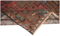 A handmade Afghan Pashm rug featuring traditional tribal patterns in red, brown, and blue tones.