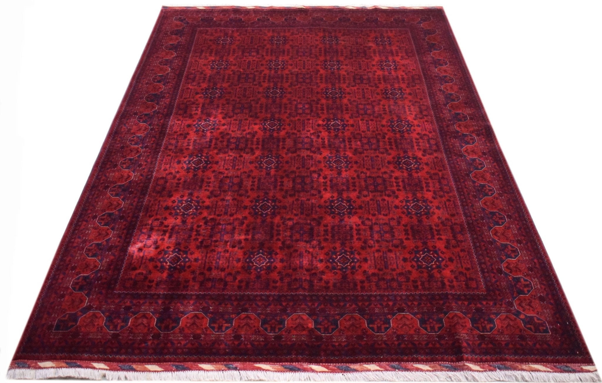 A handmade Afghan Biljik rug featuring a deep red field with intricate blue geometric patterns.