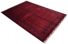 A rectangular Afghan Biljik rug featuring a deep red field with intricate blue geometric patterns.