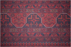 A handmade Afghan Biljik rug featuring intricate geometric patterns in deep red and blue wool.
