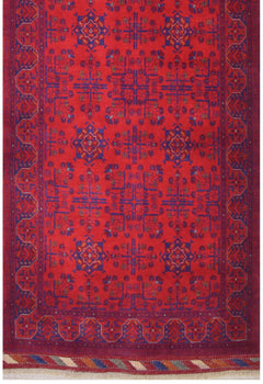 Handmade Afghan Biljik runner featuring a geometric floral pattern in deep red and blue wool.