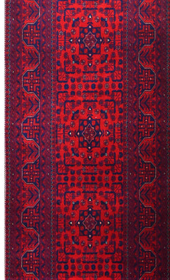 A handmade Afghan Biljik runner featuring intricate geometric patterns in deep red and blue wool.