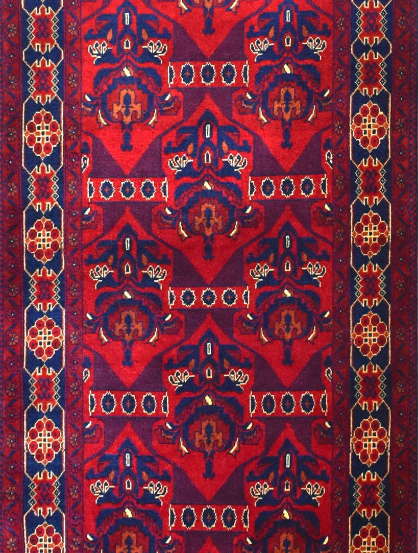 Handmade Afghan Biljik runner rug featuring deep red and blue geometric floral patterns.