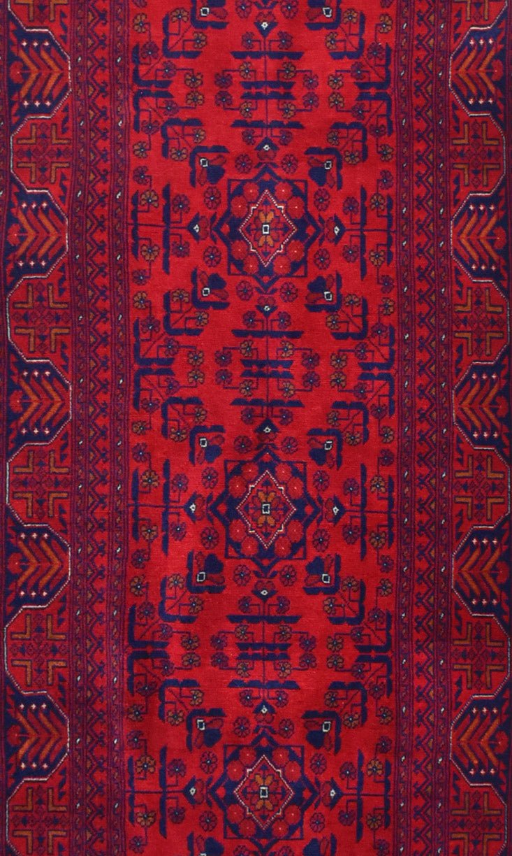 Handmade Afghan Biljik runner featuring a deep red field with intricate blue geometric patterns.
