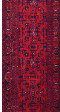 An Afghan Biljik runner rug featuring intricate geometric patterns in deep red and blue wool.